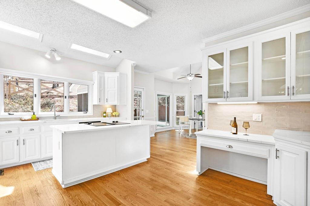 4409 Windsor Oaks Circle Marietta, GA 30066 - Photo 2 of 90 a large white kitchen with granite countertop a sink and dishwasher a stove with wooden floor