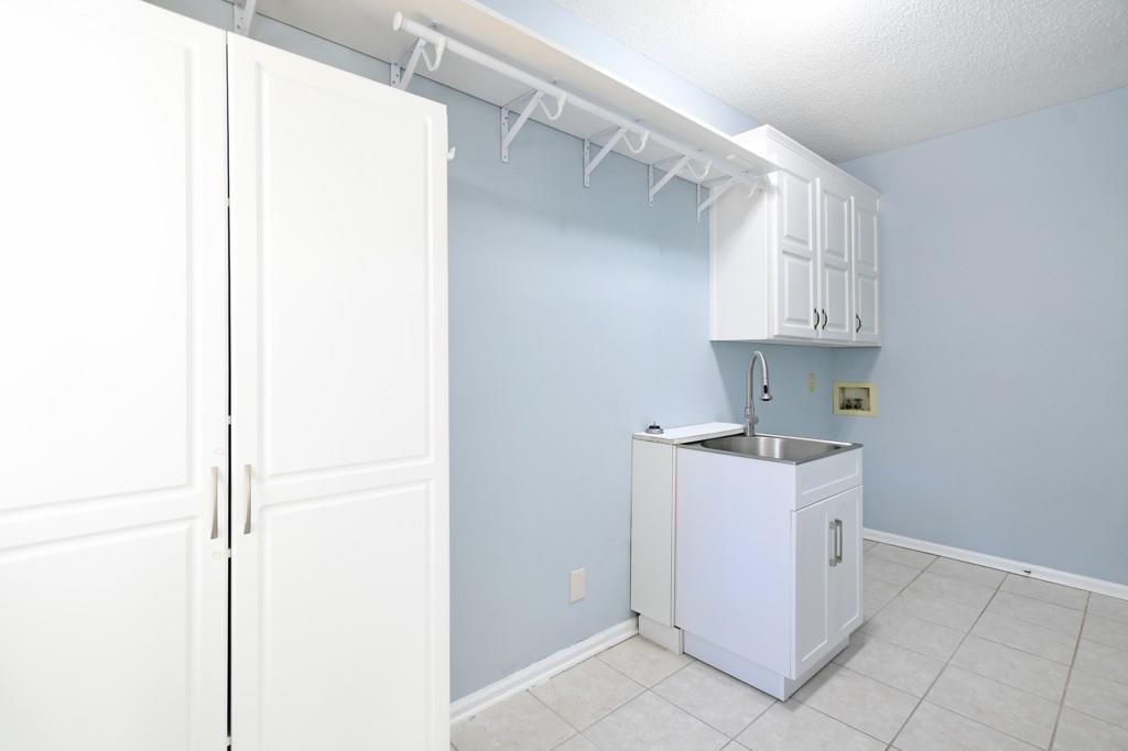 4409 Windsor Oaks Circle Marietta, GA 30066 - Photo 33 of 90 a kitchen with a sink a refrigerator and cabinets