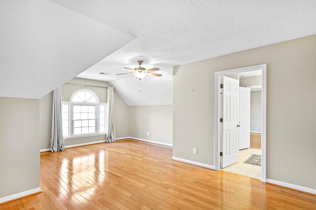 4409 Windsor Oaks Circle Marietta, GA 30066 - Photo 36 of 90 a view of an empty room with wooden floor and a window