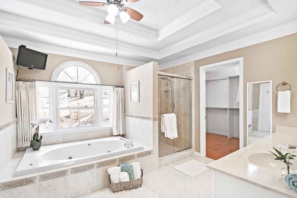 4409 Windsor Oaks Circle Marietta, GA 30066 - Photo 46 of 90 a bathroom with a tub sink and mirror