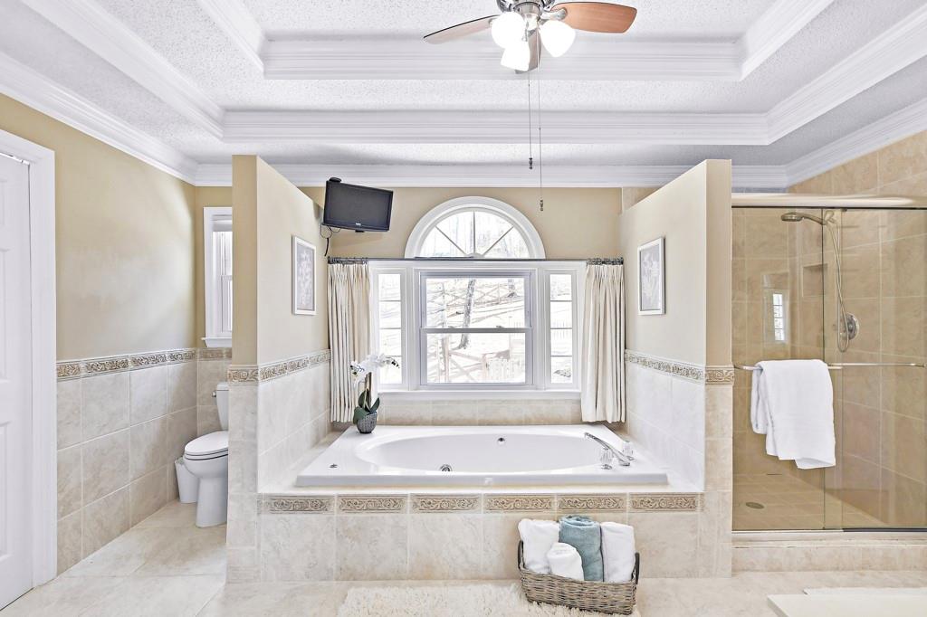 4409 Windsor Oaks Circle Marietta, GA 30066 - Photo 50 of 90 a spacious bathroom with a large tub shower and window