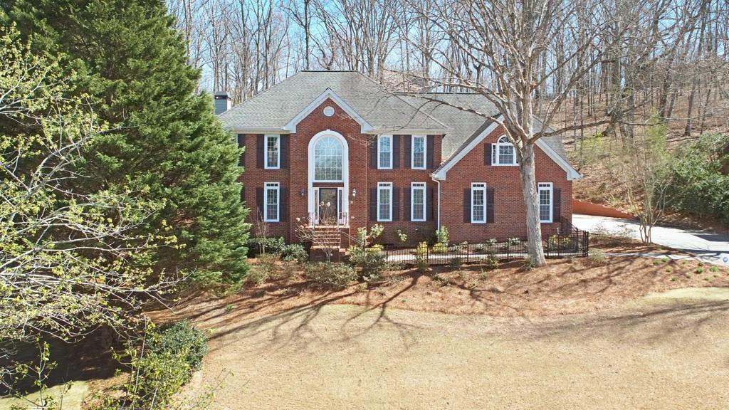 4409 Windsor Oaks Circle Marietta, GA 30066 - Photo 6 of 90 a front view of a house with a yard