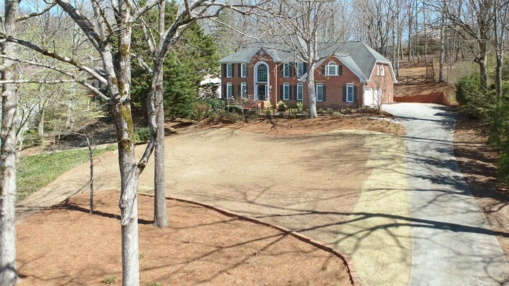 4409 Windsor Oaks Circle Marietta, GA 30066 - Photo 10 of 90 a view of a white house with a yard covered in snow