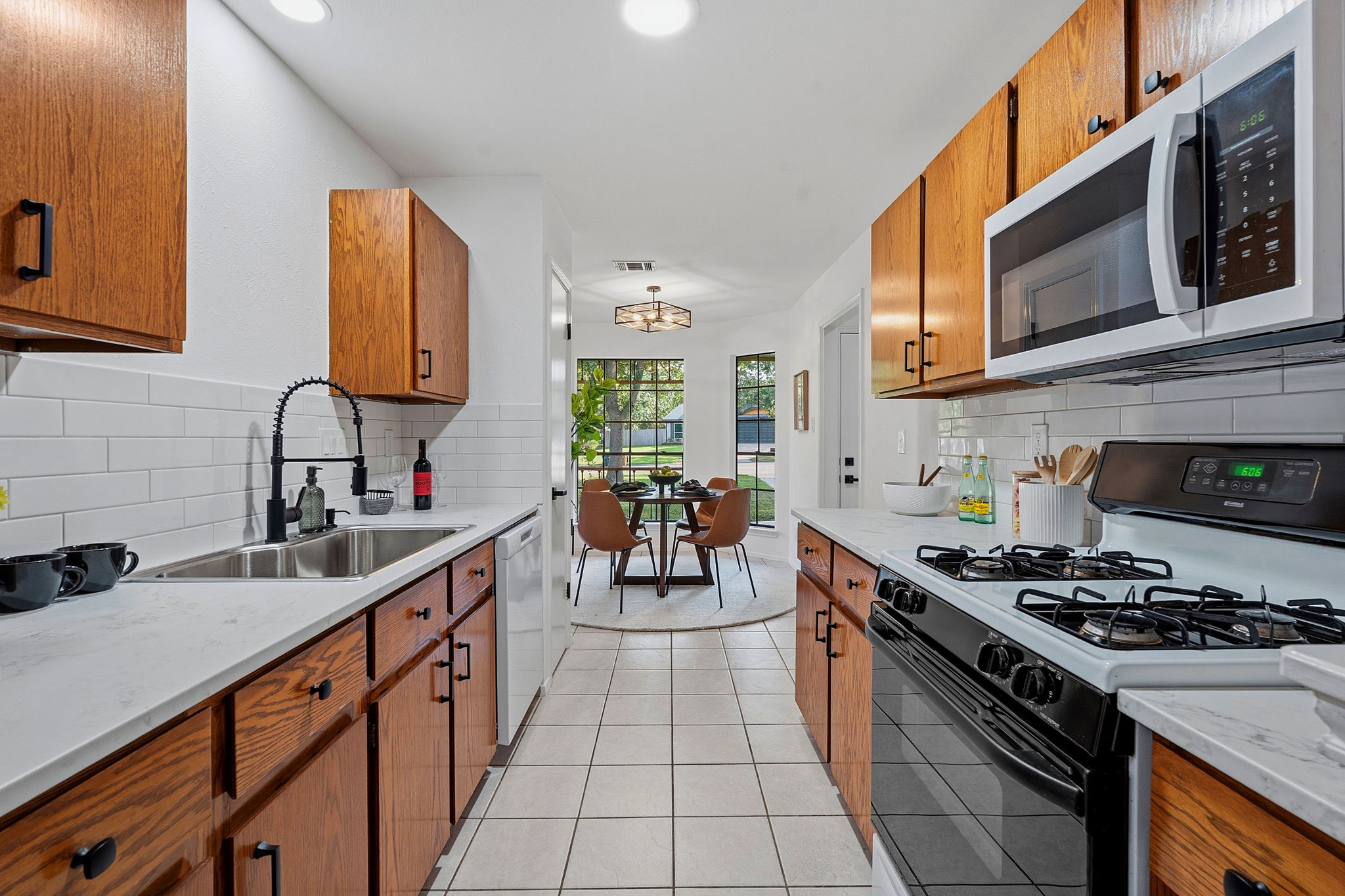 2702 Calabash Cove Austin, TX 78745 - Photo 15 of 40 a kitchen with stainless steel appliances a sink stove top oven and cabinets