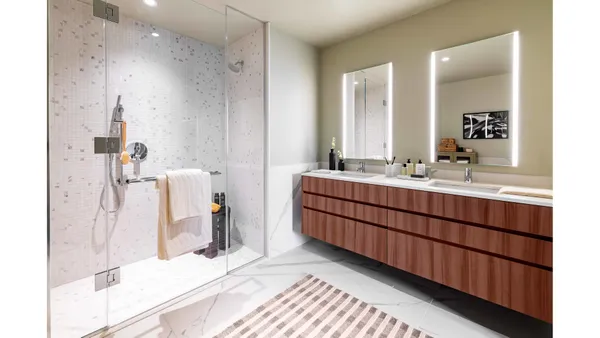 a bathroom with a double vanity sink and a mirror