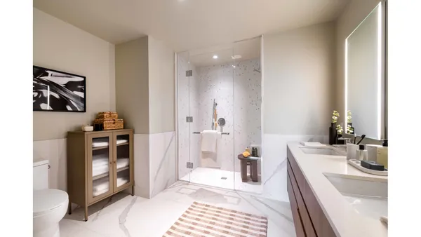 a bathroom with a sink a toilet and a shower