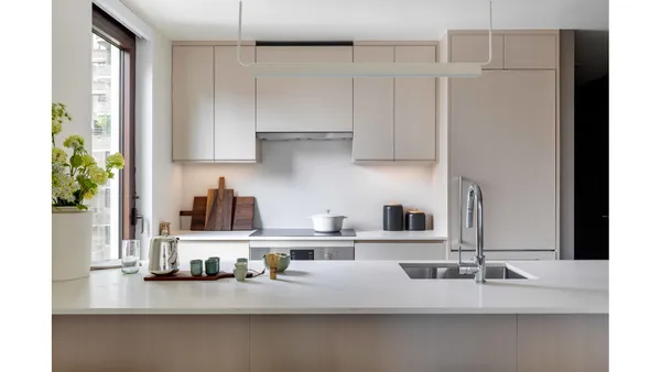a very nice looking living room with a large window and dining table