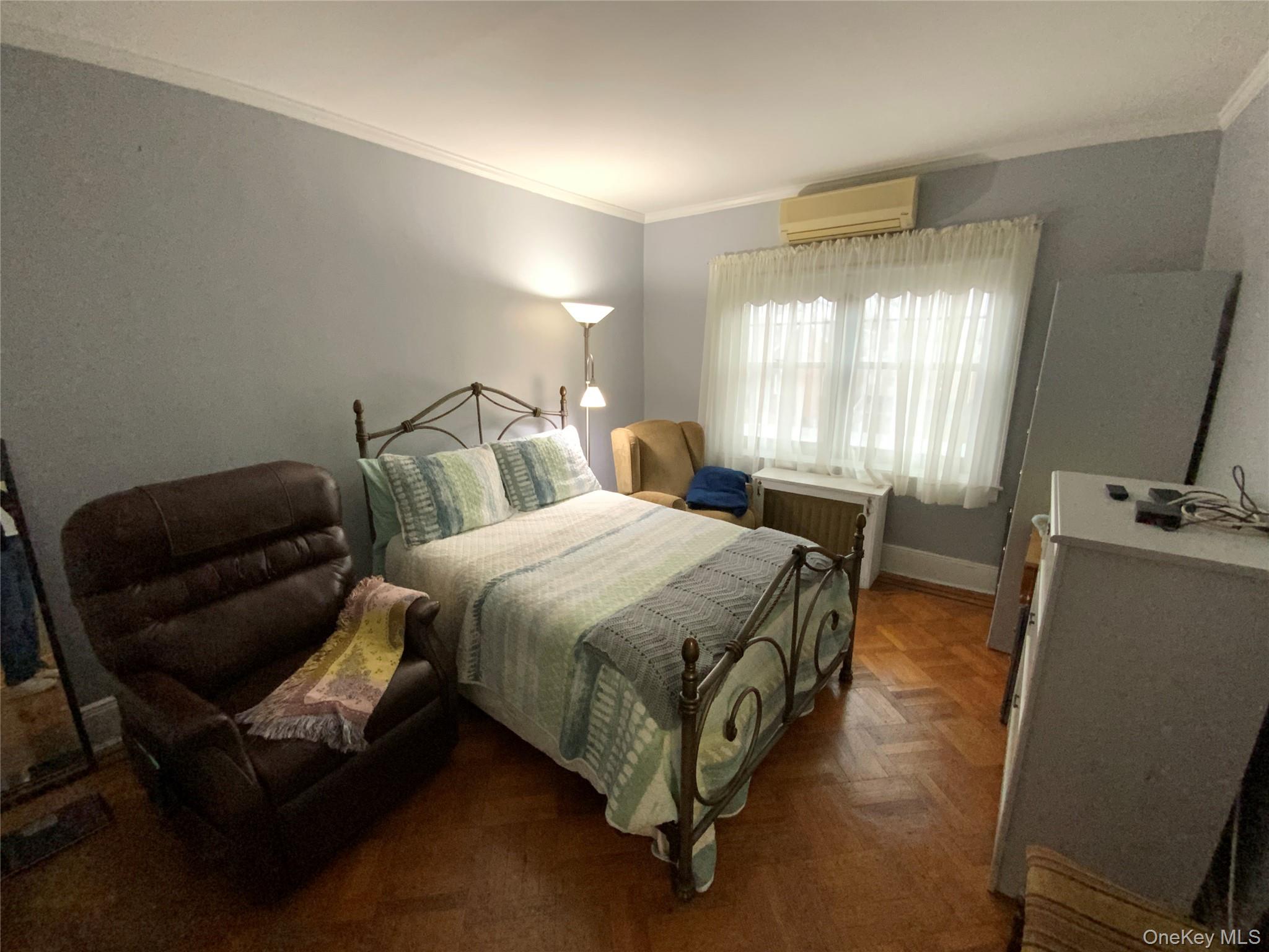 47-05 189th Street Queens, NY 11358 - Photo 19 of 41 a spacious bedroom with a bed and a couch