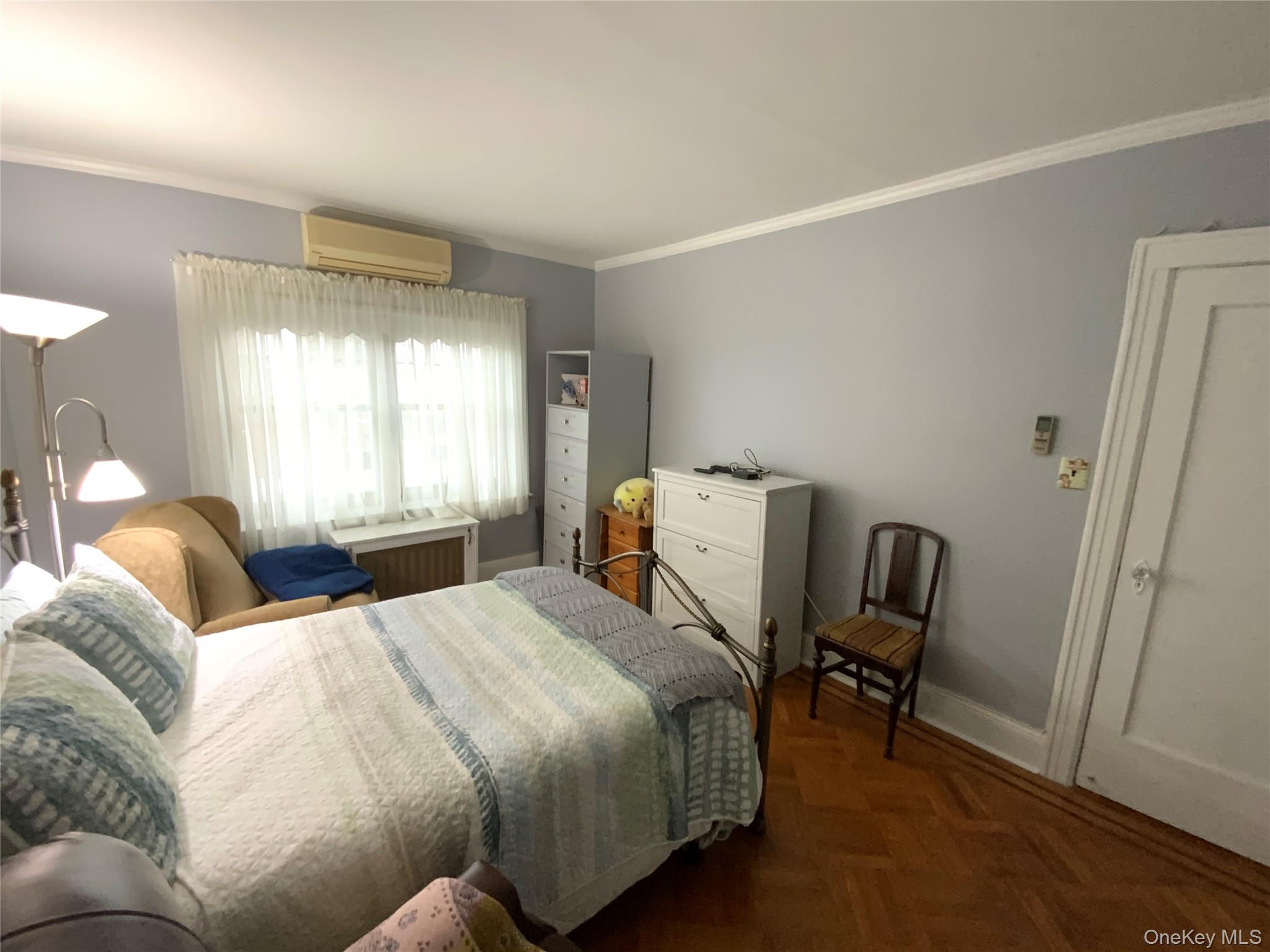 47-05 189th Street Queens, NY 11358 - Photo 20 of 41 a bedroom with a bed and a window