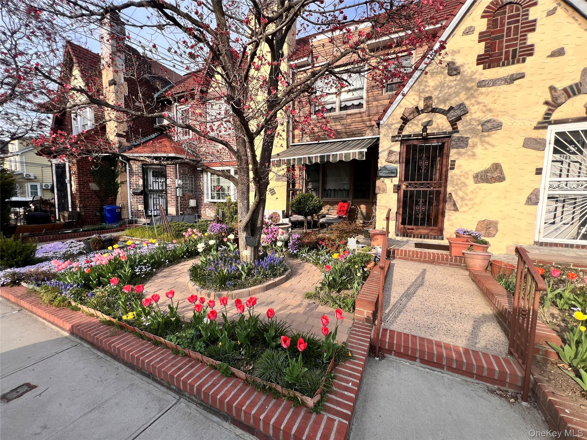 47-05 189th Street Queens, NY 11358 - Photo 2 of 41 a view of a garden with flowers and trees