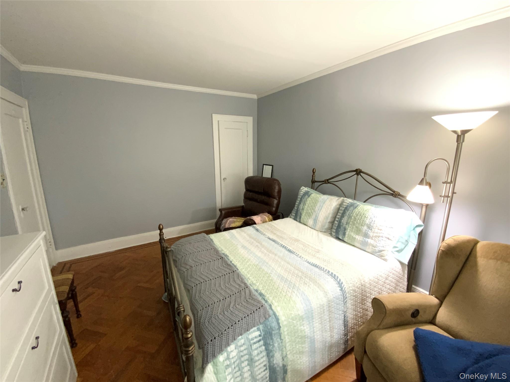 47-05 189th Street Queens, NY 11358 - Photo 21 of 41 a bedroom with a bed and a lamp