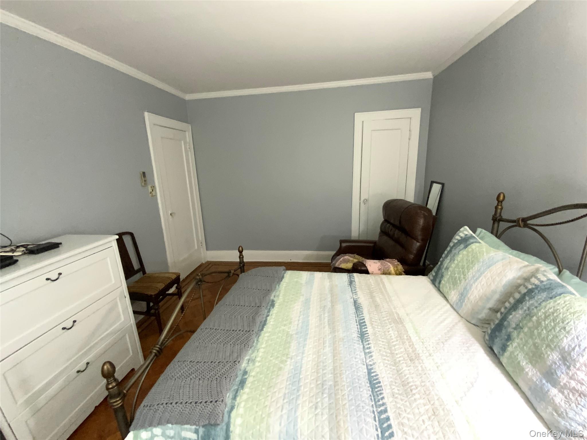 47-05 189th Street Queens, NY 11358 - Photo 22 of 41 a bedroom with a bed and wooden floor