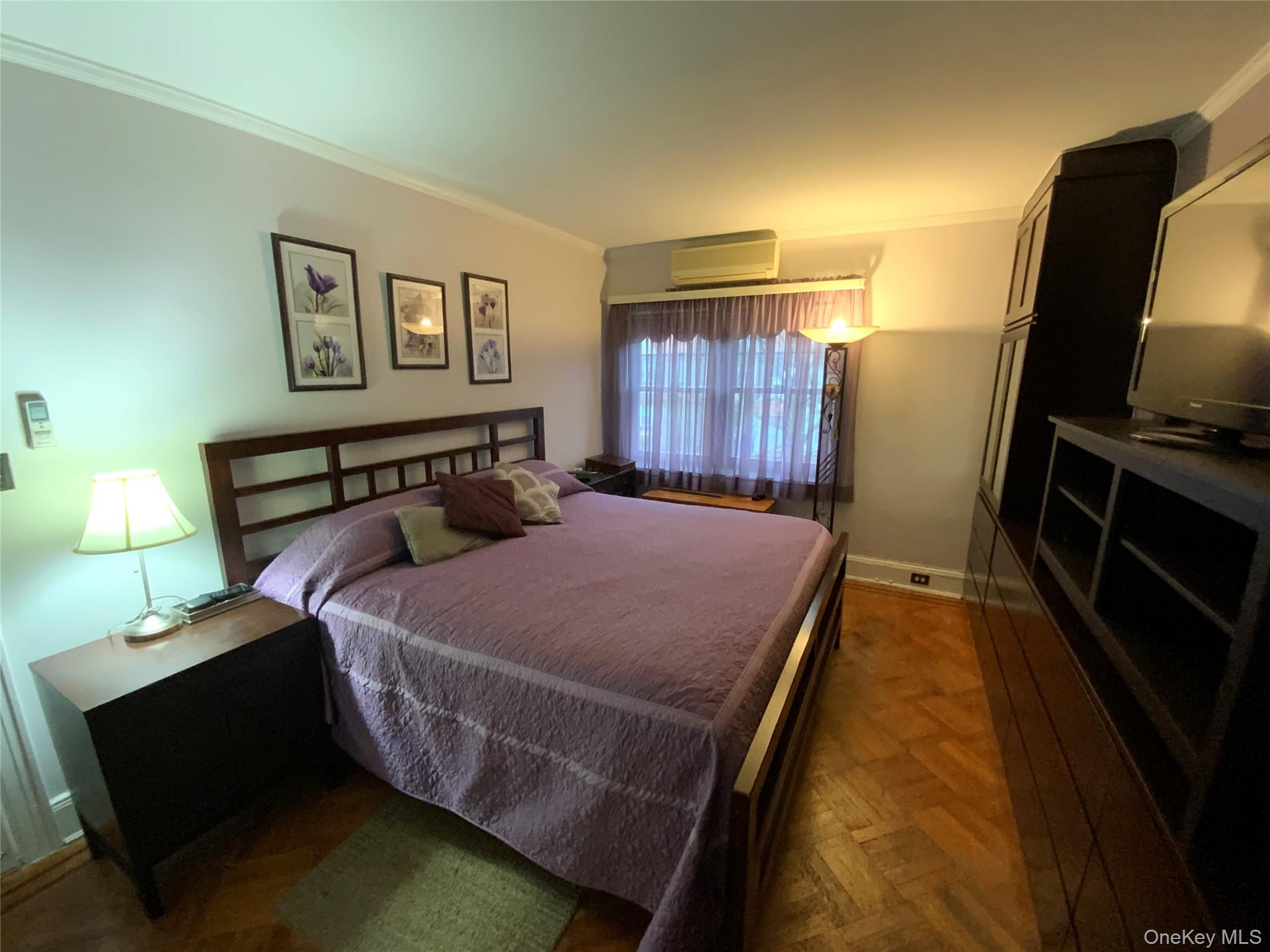 47-05 189th Street Queens, NY 11358 - Photo 23 of 41 a bedroom with a bed and wooden floor