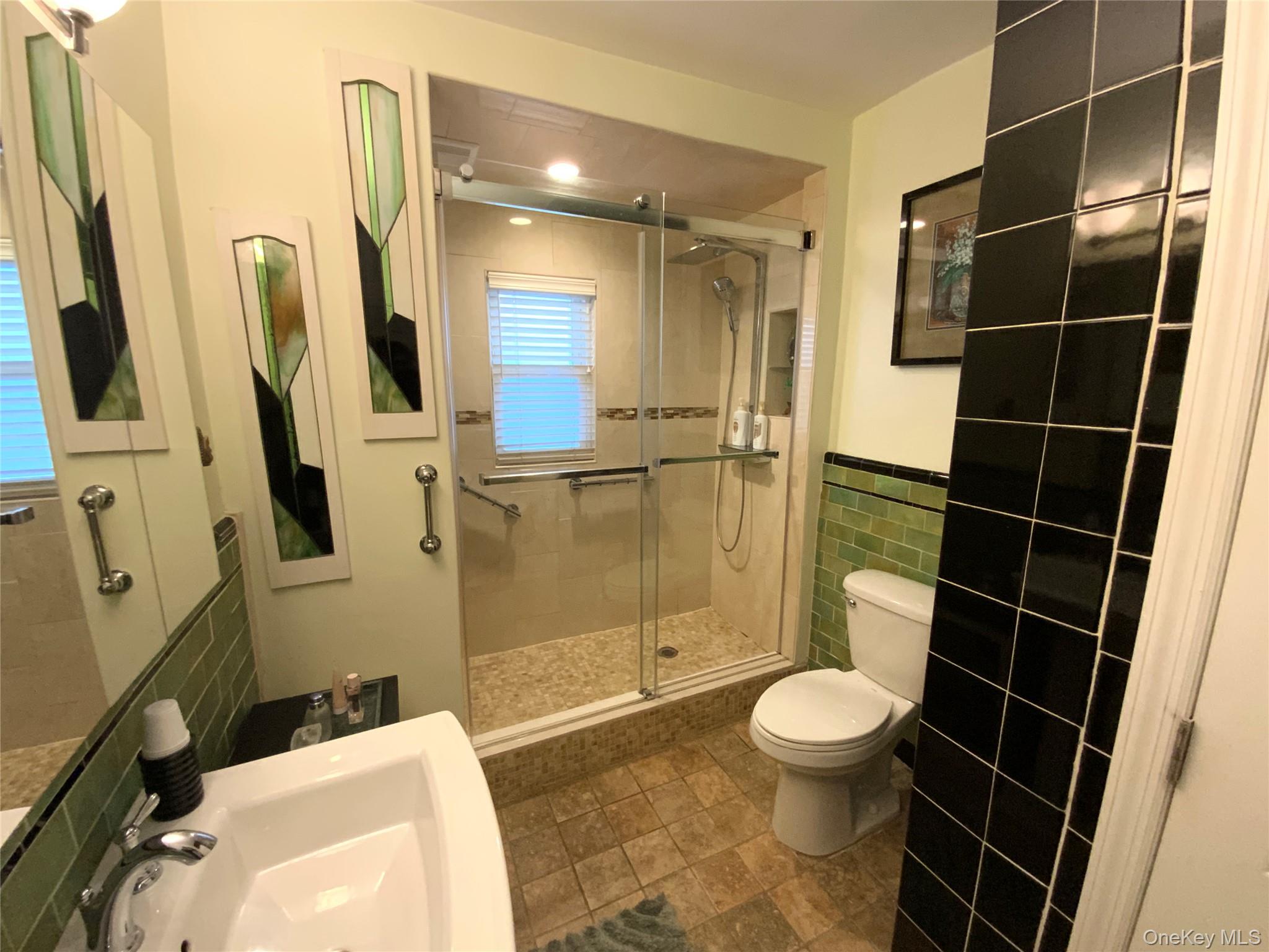47-05 189th Street Queens, NY 11358 - Photo 27 of 41 a bathroom with a toilet and a shower