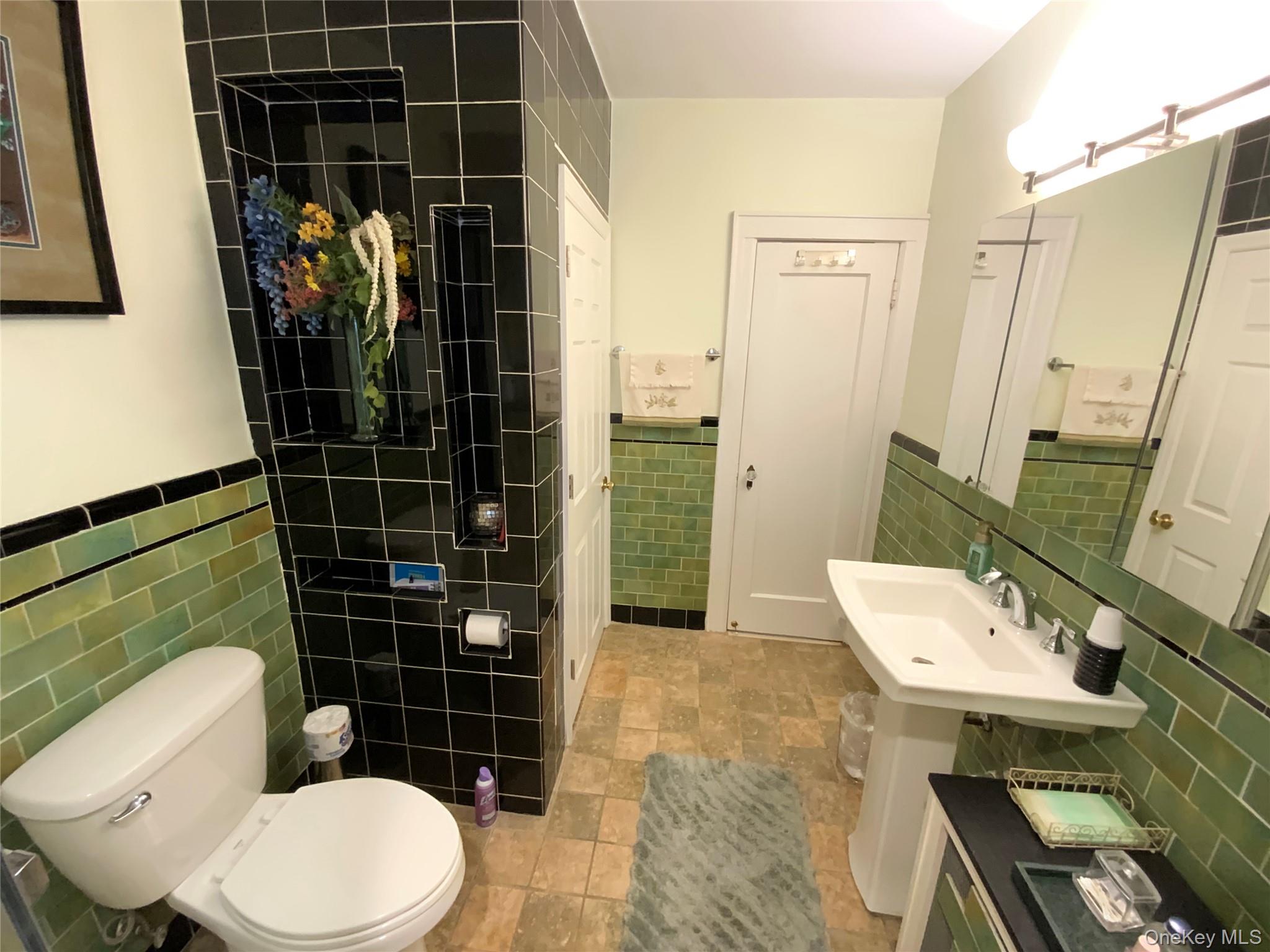 47-05 189th Street Queens, NY 11358 - Photo 28 of 41 a bathroom with a toilet a sink and shower