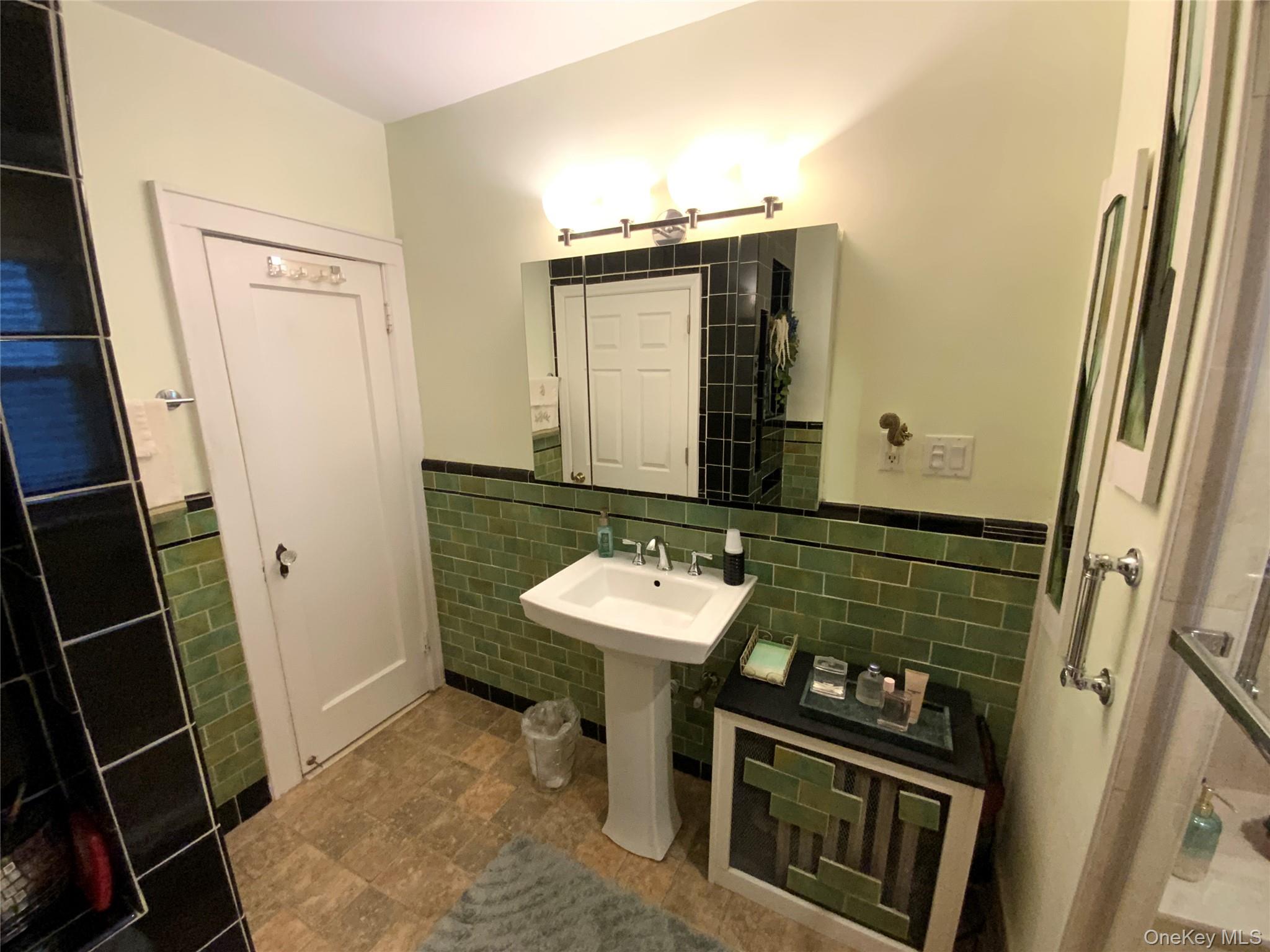 47-05 189th Street Queens, NY 11358 - Photo 29 of 41 a bathroom with a sink and a mirror