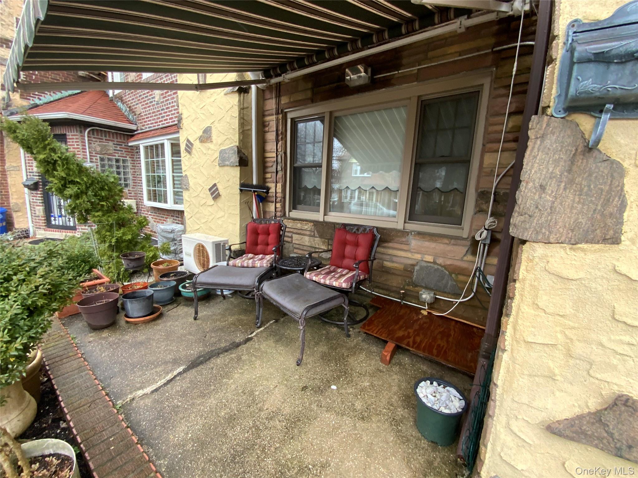 47-05 189th Street Queens, NY 11358 - Photo 38 of 41 a living room with furniture and a potted plant