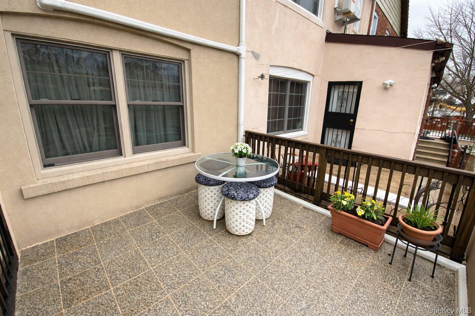 47-05 189th Street Queens, NY 11358 - Photo 40 of 41 a view of a patio with chair and the potted plants
