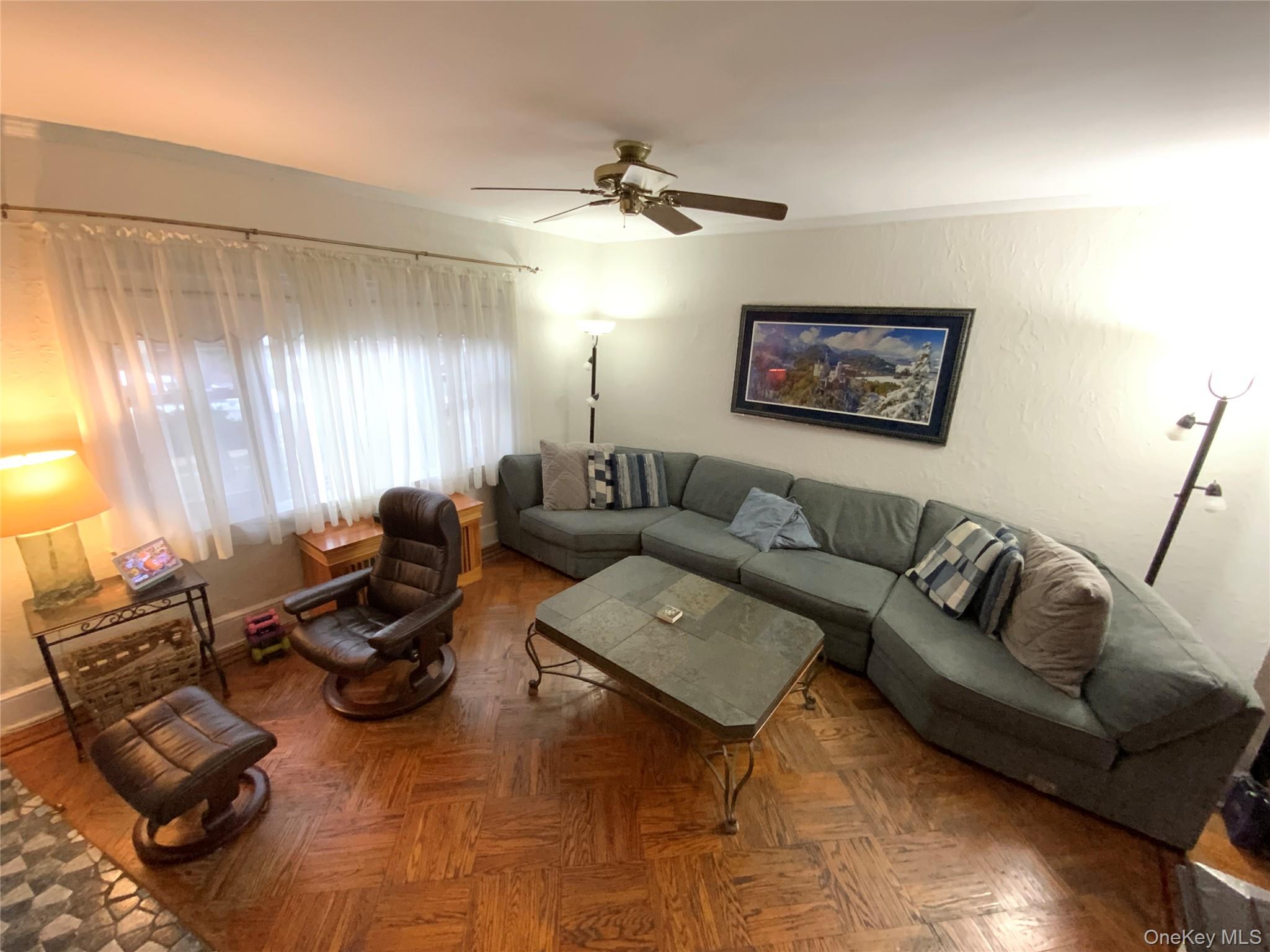 47-05 189th Street Queens, NY 11358 - Photo 6 of 41 a living room with furniture a rug and a window