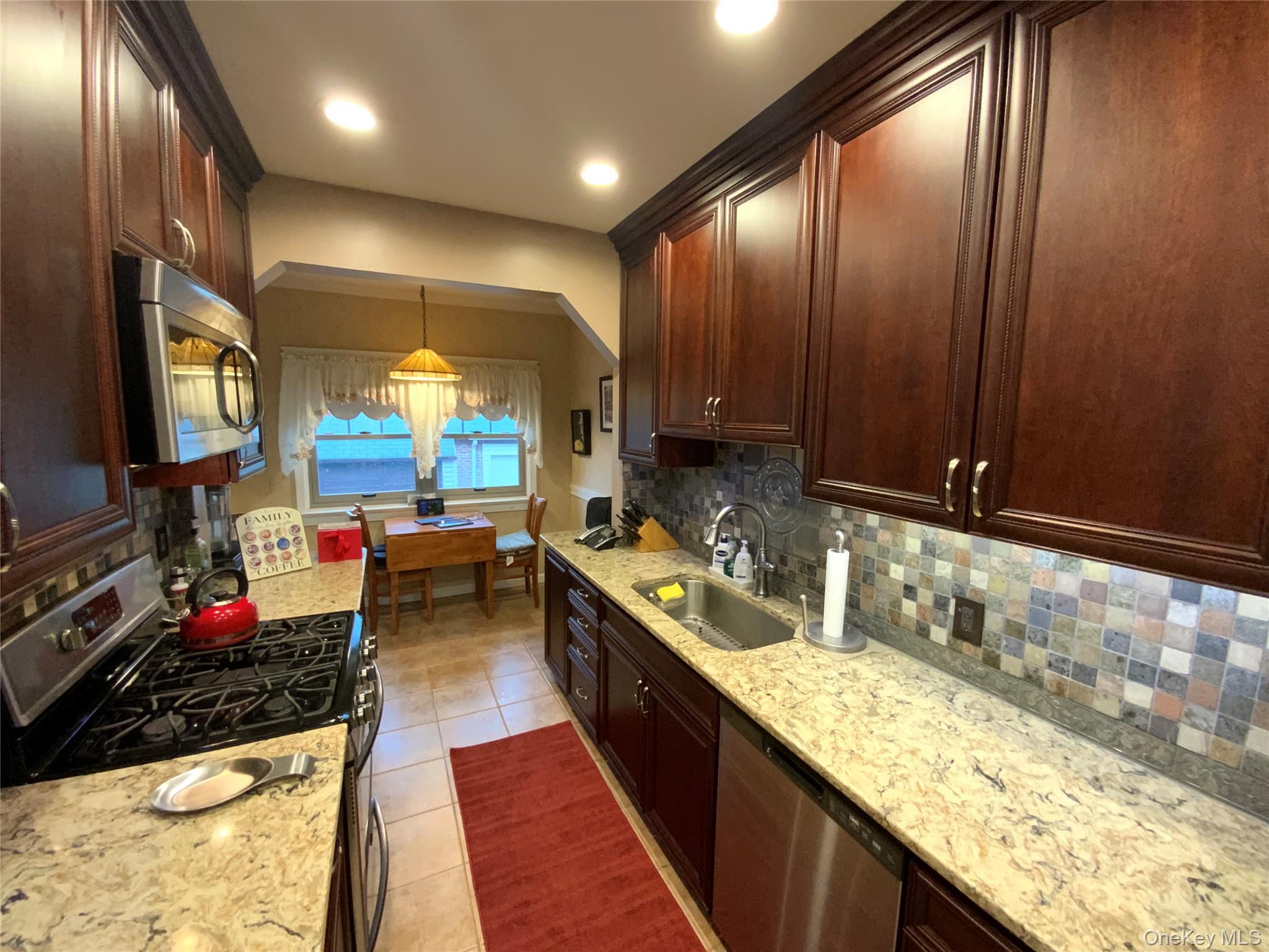 47-05 189th Street Queens, NY 11358 - Photo 9 of 41 a kitchen with lots of counter top space and living room