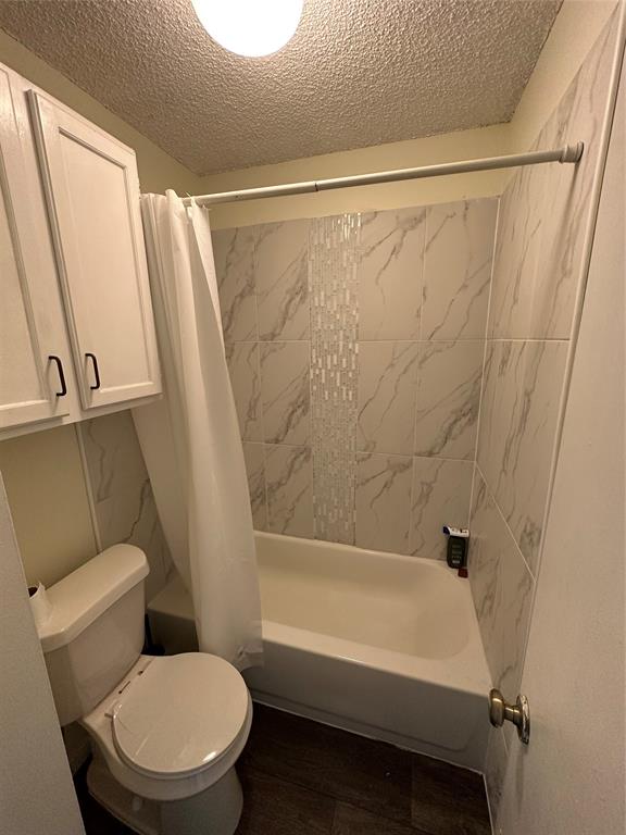 2815 Rio Grande Street, Unit 205 Austin, TX 78705 - Photo 4 of 20 a white toilet sitting next to a bath tub