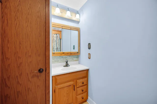 a bathroom with a sink and a mirror