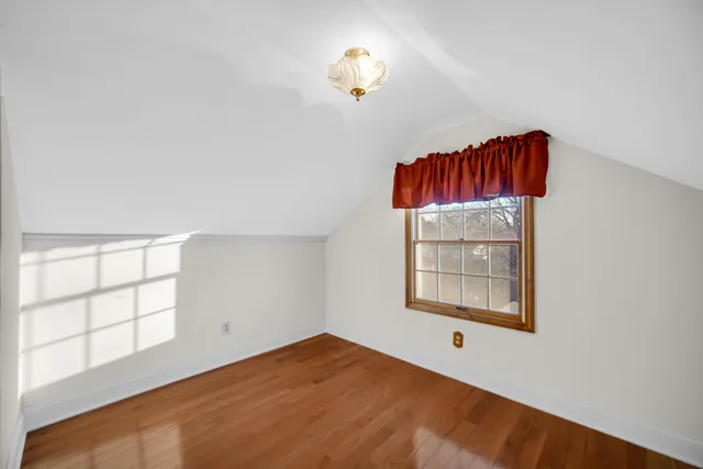an empty room with windows and cabinet