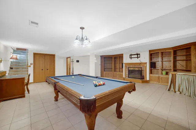 a room with pool table and windows
