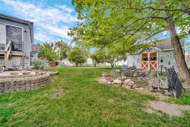 a backyard of a house with lots of green space and fountain