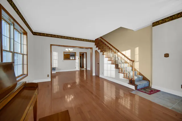 a view of an entryway with wooden floor
