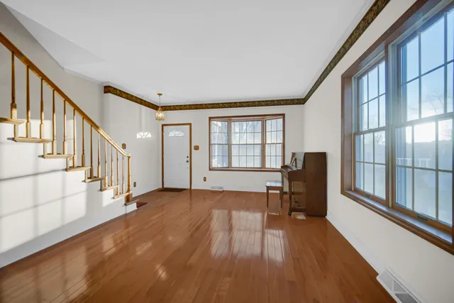 a view of a livingroom with wooden floor and furniture