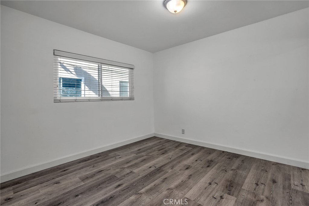 3706 Redondo Beach Boulevard, Unit B Torrance, CA 90504 - Photo 15 of 18 an empty room with wooden floor and windows