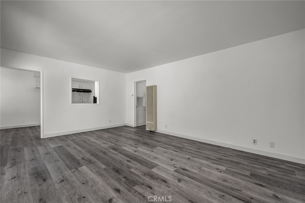 3706 Redondo Beach Boulevard, Unit B Torrance, CA 90504 - Photo 4 of 18 a view of an empty room with wooden floor and a window