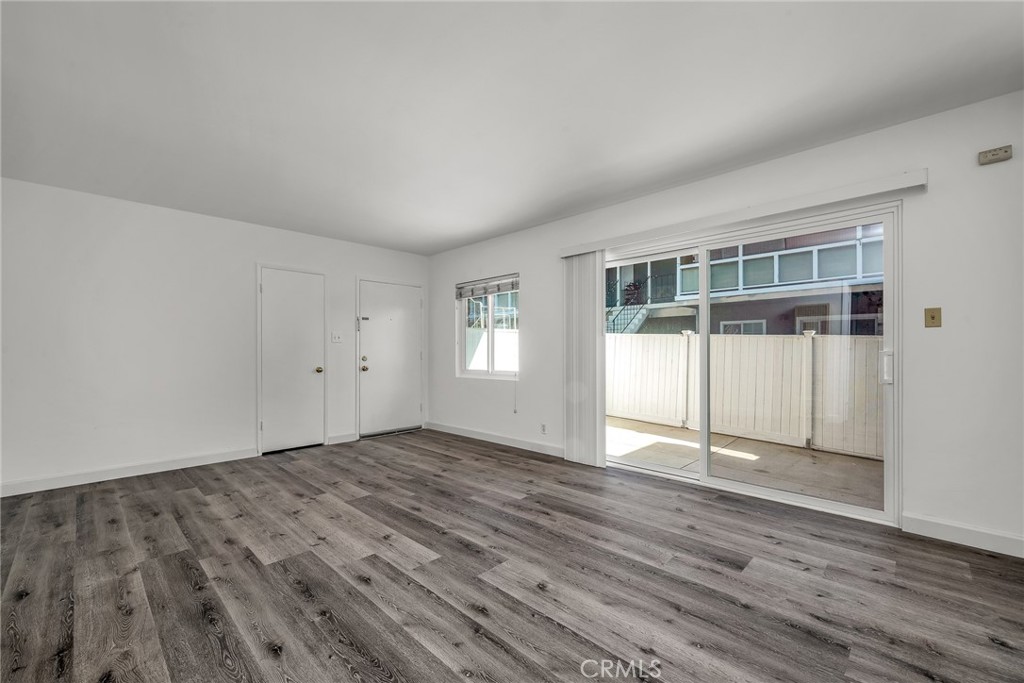 3706 Redondo Beach Boulevard, Unit B Torrance, CA 90504 - Photo 5 of 18 a view of an empty room with wooden floor and a window