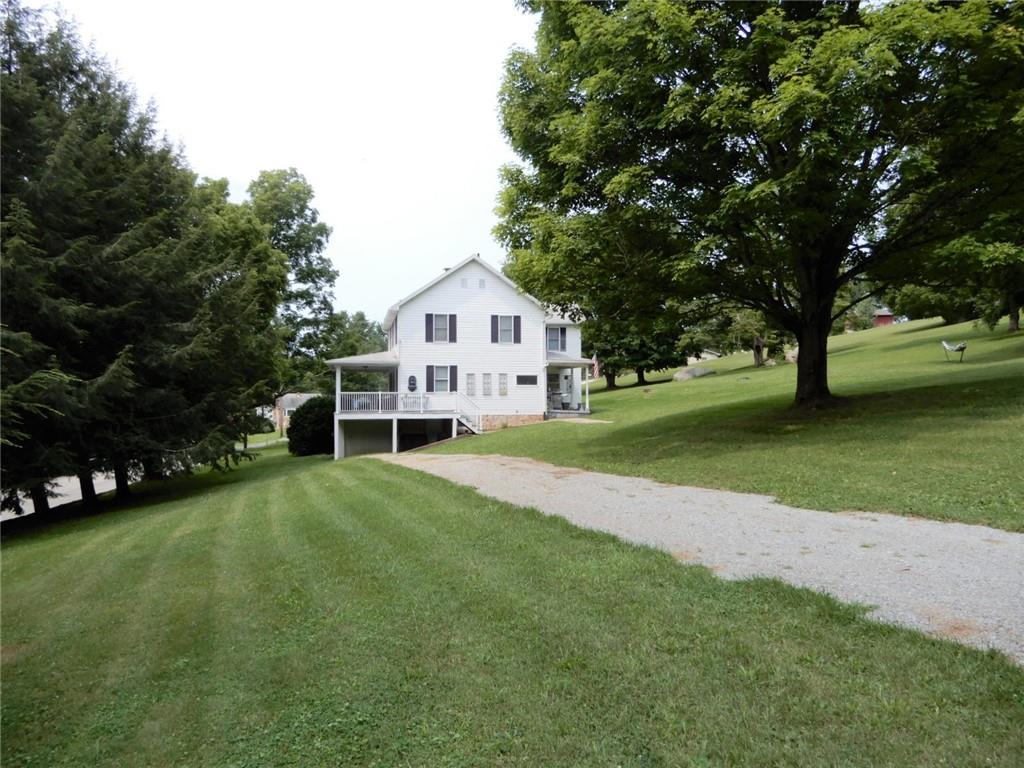 590 Imel Road Normalville, PA 15469 - Photo 27 of 30 a view of a house with a big yard and large trees