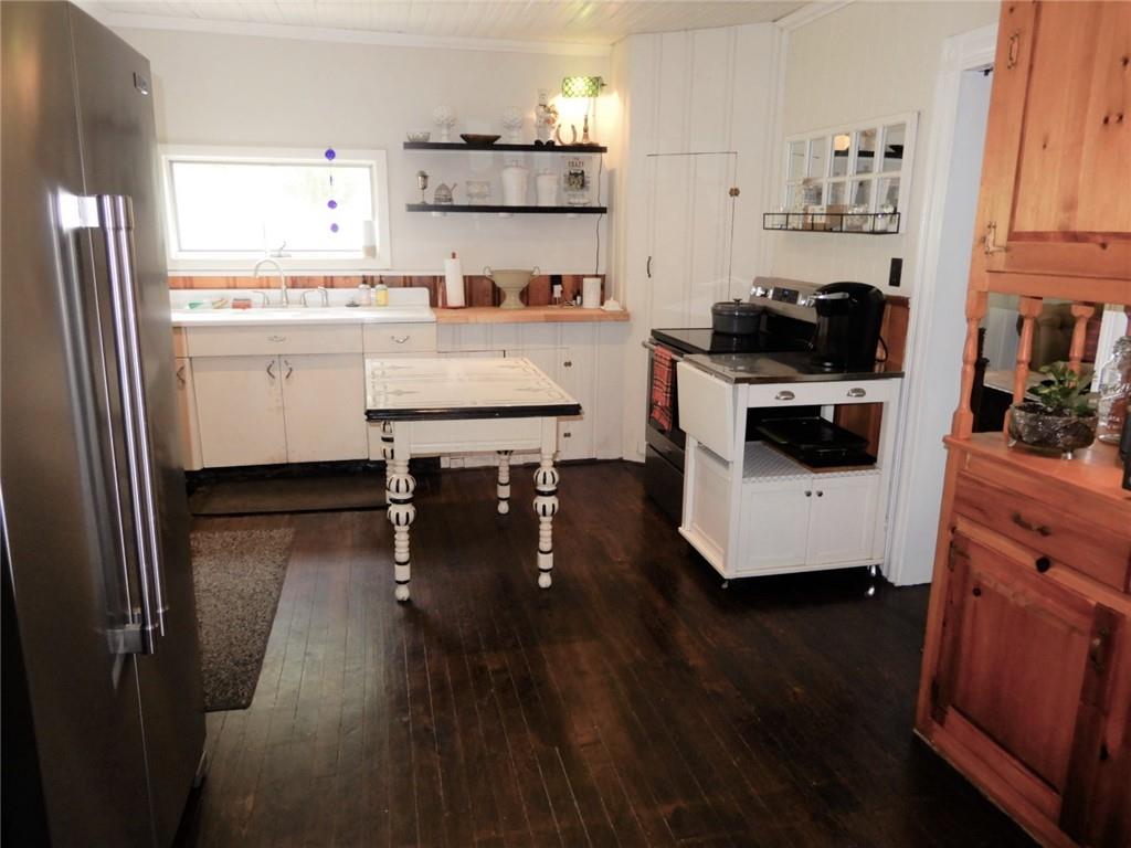 590 Imel Road Normalville, PA 15469 - Photo 10 of 30 a kitchen with stainless steel appliances a stove a refrigerator and white cabinets