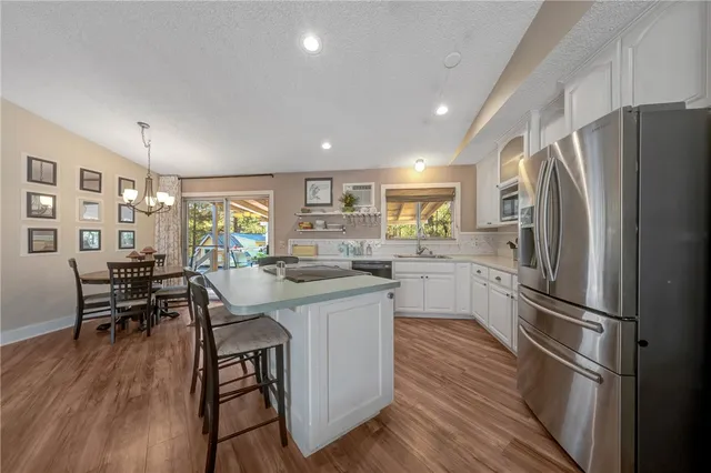 a bedroom with a bed and a view of kitchen