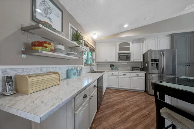 a bathroom with a glass door shower and a sink