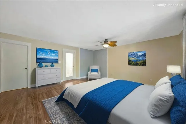 a living room with furniture a flat screen tv and a floor to ceiling window