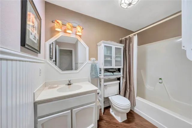 a kitchen with counter top space and wooden floor