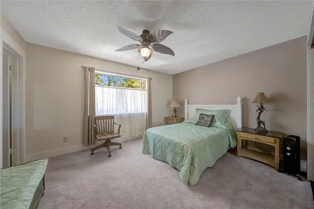 an aerial view of a house with garden space and sitting area