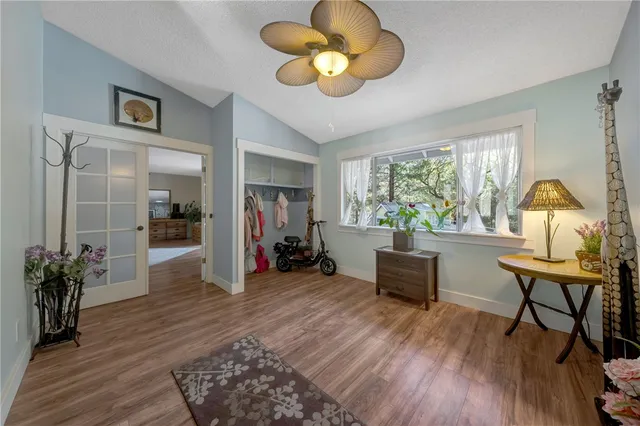 a kitchen with kitchen island white cabinets and stainless steel appliances
