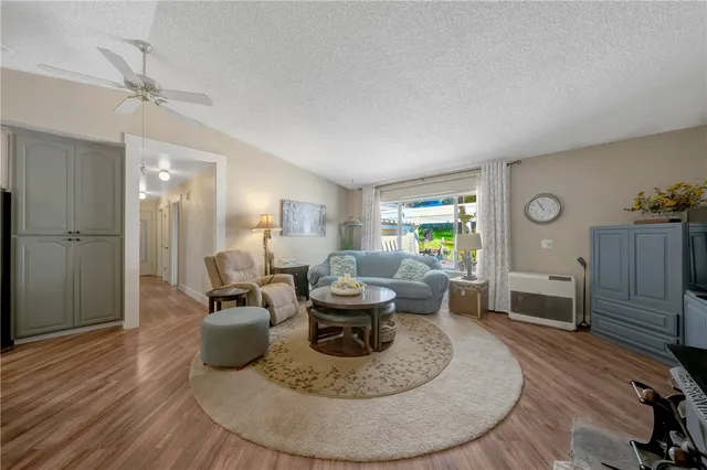 a dining room with furniture a chandelier and wooden floor