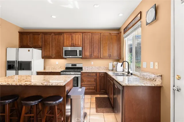 a balcony with chairs and stove
