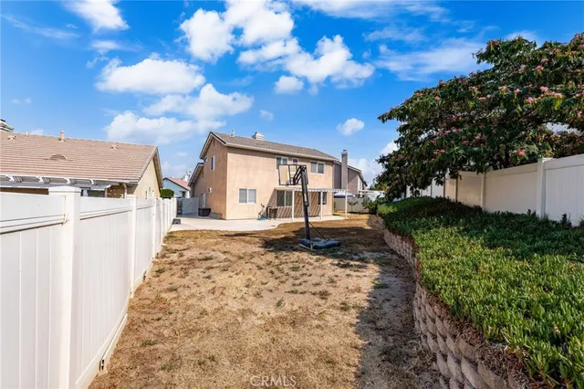 a view of house with backyard and deck