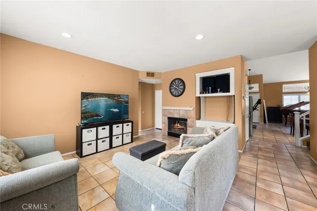 a living room with fireplace furniture and a fireplace