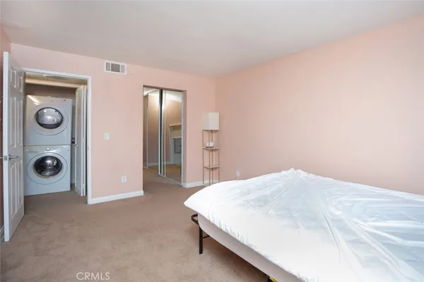 a bedroom with a bed and a mirror