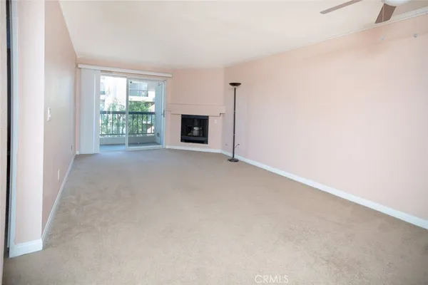 a view of an empty room with a fireplace