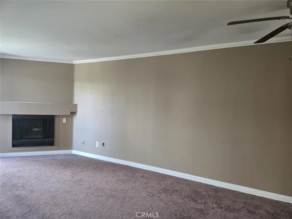 a view of an empty room with a fireplace