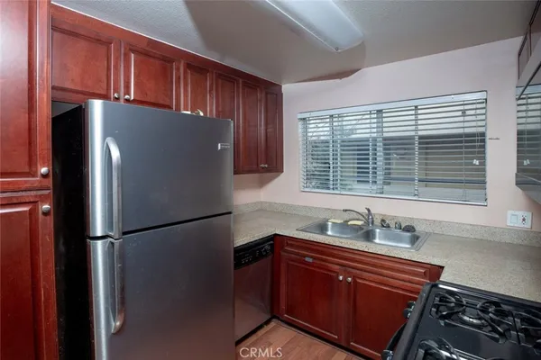 a kitchen with stainless steel appliances granite countertop a refrigerator and a sink